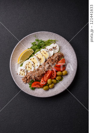 Salad with tuna pieces, boiled egg, cherry tomatoes, lettuce 121441633