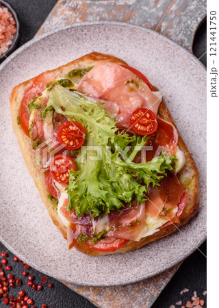 Ciabata with jamon or prosciutto, tomatoes, cheese and lettuce Ciabata with jamon or prosciutto, tomatoes, cheese and lettuce 121441750