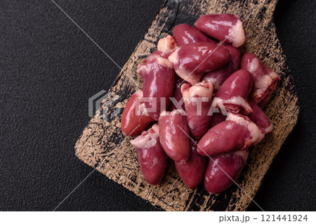 Raw chicken hearts with salt, spices and herbs 121441924
