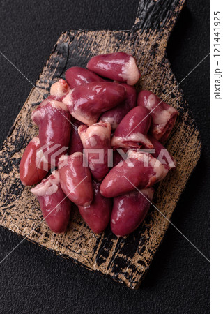 Raw chicken hearts with salt, spices and herbs 121441925