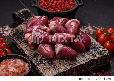 Raw chicken hearts with salt, spices and herbs Raw chicken hearts with salt, spices and herbs 121441926