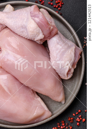 Pieces of raw chicken or turkey fillet with salt, spices and herbs 121442013