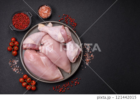 Pieces of raw chicken or turkey fillet with salt, spices and herbs Pieces of raw chicken or turkey fillet with salt, spices and herbs 121442015
