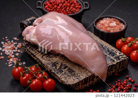 Pieces of raw chicken or turkey fillet with salt, spices and herbs Pieces of raw chicken or turkey fillet with salt, spices and herbs 121442023