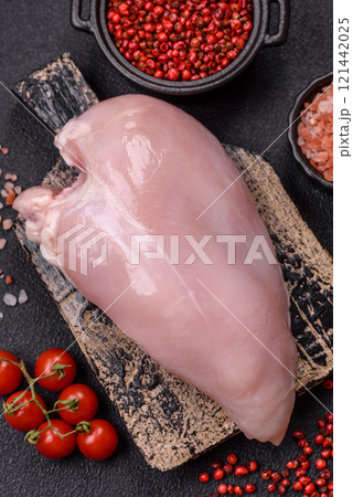 Pieces of raw chicken or turkey fillet with salt, spices and herbs Pieces of raw chicken or turkey fillet with salt, spices and herbs 121442025