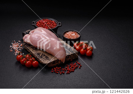 Pieces of raw chicken or turkey fillet with salt, spices and herbs Pieces of raw chicken or turkey fillet with salt, spices and herbs 121442026