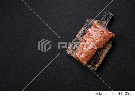 Pork ribs in sweet and sour sauce with salt and spices 121442059