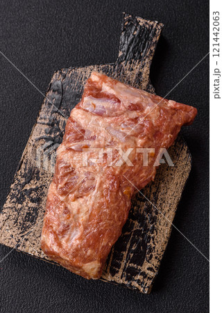 Pork ribs in sweet and sour sauce with salt and spices 121442063