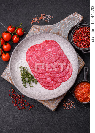 Delicious smoked salami sausage with salt, spices and herbs 121442206