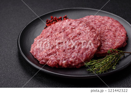 Fresh raw ground beef burger patty with salt and spices Fresh raw ground beef burger patty with salt and spices 121442322