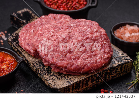 Fresh raw ground beef burger patty with salt and spices Fresh raw ground beef burger patty with salt and spices 121442337