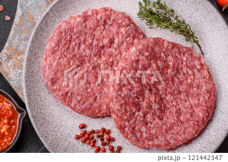 Fresh raw ground beef burger patty with salt and spices Fresh raw ground beef burger patty with salt and spices 121442347