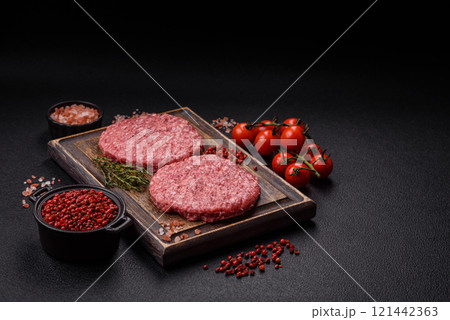 Fresh raw ground beef burger patty with salt and spices Fresh raw ground beef burger patty with salt and spices 121442363