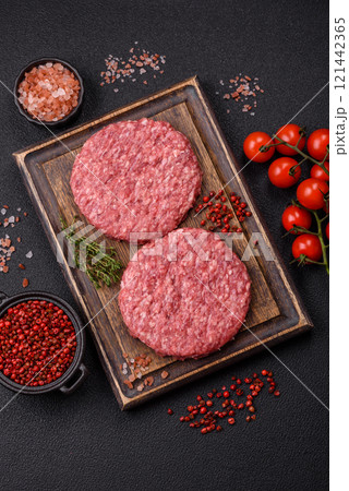 Fresh raw ground beef burger patty with salt and spices Fresh raw ground beef burger patty with salt and spices 121442365