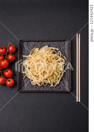 Rice noodles with beans, meat, tomato sauce, spices and herbs 121442425