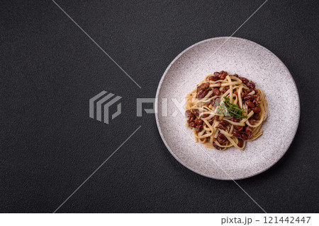 Rice noodles with beans, meat, tomato sauce, spices and herbs 121442447