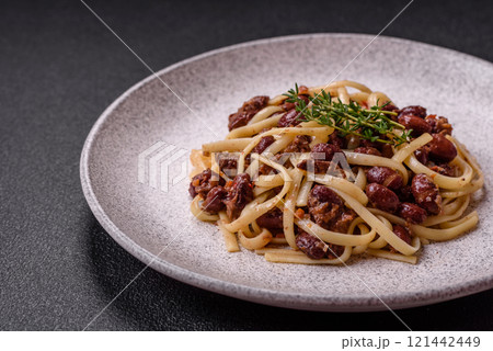 Rice noodles with beans, meat, tomato sauce, spices and herbs Rice noodles with beans, meat, tomato sauce, spices and herbs 121442449