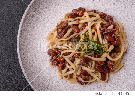 Rice noodles with beans, meat, tomato sauce, spices and herbs Rice noodles with beans, meat, tomato sauce, spices and herbs 121442450