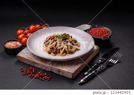 Rice noodles with beans, meat, tomato sauce, spices and herbs Rice noodles with beans, meat, tomato sauce, spices and herbs 121442455