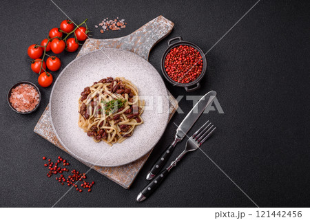 Rice noodles with beans, meat, tomato sauce, spices and herbs Rice noodles with beans, meat, tomato sauce, spices and herbs 121442456