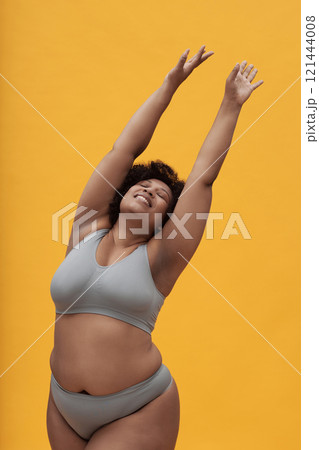 Happy Body Positive Woman Stretching Her Arms 121444008