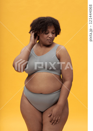 Body Positive Girl Against Yellow Background 121444068