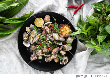 Fresh clams and mussels are prepared with garlic, herbs, and lime for a flavorful seafood feast. Fresh clams and mussels are prepared with garlic, herbs, and lime for a flavorful seafood feast. 121445374