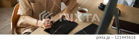 Graphic Designer Working On Tablet Graphic Designer Working On Tablet 121445618
