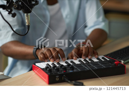 Man Playing Mixing Console In Studio 121445713