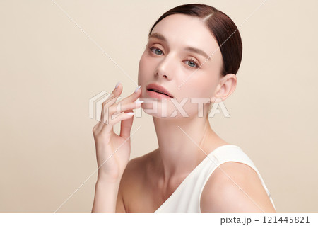 Beautiful young woman with clean fresh skin on beige background, Face care, Facial treatment, Cosmetology, beauty and spa, women portrait. 121445821
