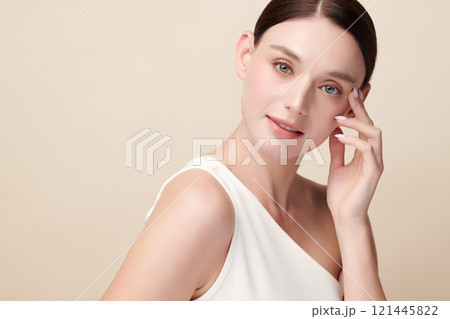 Beautiful young woman with clean fresh skin on beige background, Face care, Facial treatment, Cosmetology, beauty and spa, women portrait. 121445822