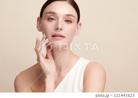 Beautiful young woman with clean fresh skin on beige background, Face care, Facial treatment, Cosmetology, beauty and spa, women portrait. 121445823