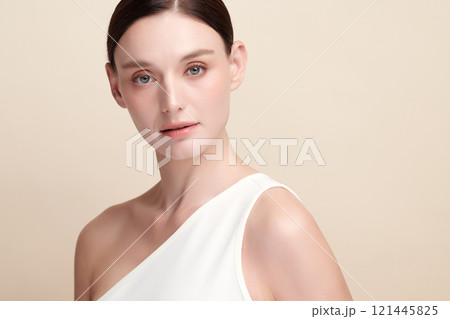 Beautiful young woman with clean fresh skin on beige background, Face care, Facial treatment, Cosmetology, beauty and spa, women portrait. 121445825