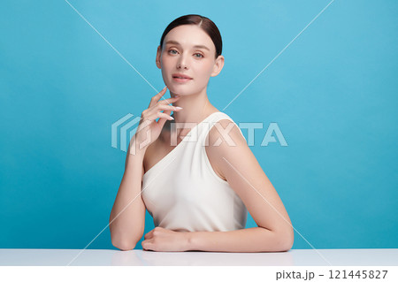 Beautiful young woman with clean fresh skin on blue background, Face care, Facial treatment, Cosmetology, beauty and spa, women portrait. 121445827