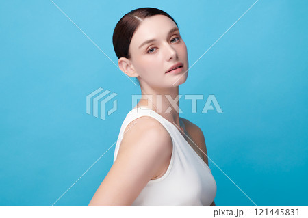 Beautiful young woman with clean fresh skin on blue background, Face care, Facial treatment, Cosmetology, beauty and spa, women portrait. Beautiful young woman with clean fresh skin on blue background, Face care, Facial treatment, Cosmetology, beauty and spa, women portrait. 121445831