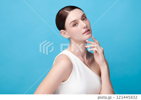 Beautiful young woman with clean fresh skin on blue background, Face care, Facial treatment, Cosmetology, beauty and spa, women portrait. 121445832