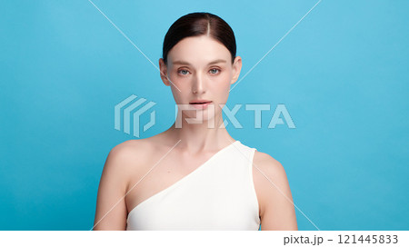 Beautiful young woman with clean fresh skin on blue background, Face care, Facial treatment, Cosmetology, beauty and spa, women portrait. 121445833