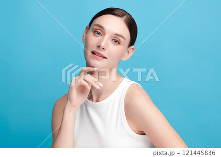 Beautiful young woman with clean fresh skin on blue background, Face care, Facial treatment, Cosmetology, beauty and spa, women portrait. 121445836