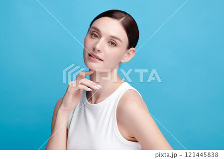 Beautiful young woman with clean fresh skin on blue background, Face care, Facial treatment, Cosmetology, beauty and spa, women portrait. Beautiful young woman with clean fresh skin on blue background, Face care, Facial treatment, Cosmetology, beauty and spa, women portrait. 121445838