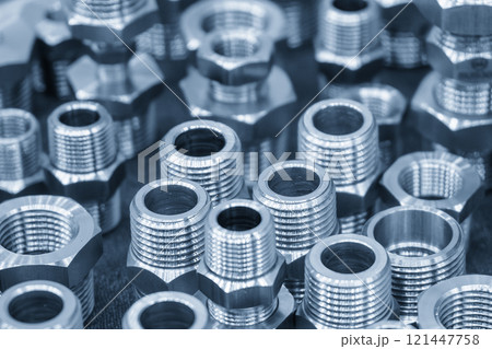 The pile of steel water pipe connector parts in the light blue scene. The pile of steel water pipe connector parts in the light blue scene. 121447758