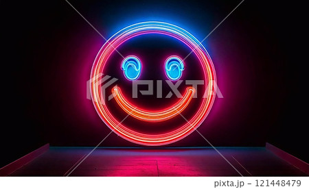 A neon smiley face glows brightly, spreading cheer in a dark space 121448479