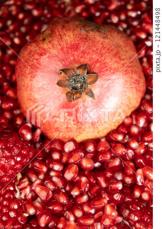 A whole pomegranate and pomegranate grains close-up. A whole pomegranate and pomegranate grains close-up. 121448498