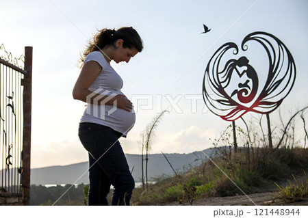composite image of fit brunette with hands on hips 121448944