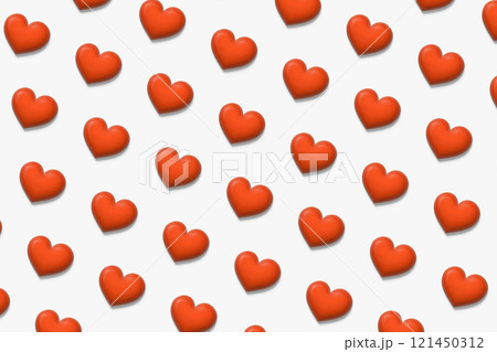 立体的なぷっくりした木製の赤いハートが白い背景に並ぶパターン背景 121450312