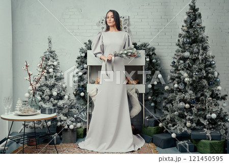 Stylish Woman in Elegant Dress with Holiday Background. 121450595