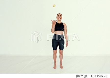 Trainer Tossing Tennis Ball with Focus. 121450779