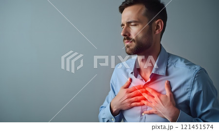 Man Experiencing Severe Chest Pain Highlighted with Red Glow, Suggesting a Cardiac Emergency 121451574