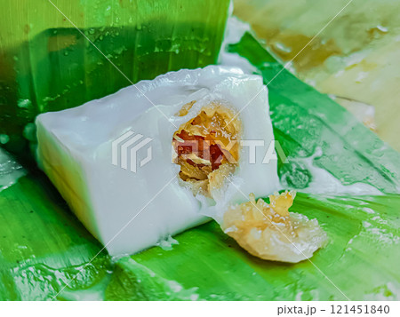 Steamed flour with coconut filling wrapped with banana leaf, Kanom sai sai. Steamed flour with coconut filling wrapped with banana leaf, Kanom sai sai. 121451840