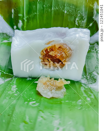 Steamed flour with coconut filling wrapped with banana leaf, Kanom sai sai. 121451841
