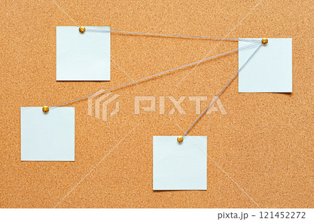 Blank paper notes are pinned to a cork board. The concept of detective investigation or training. Copy space. 121452272